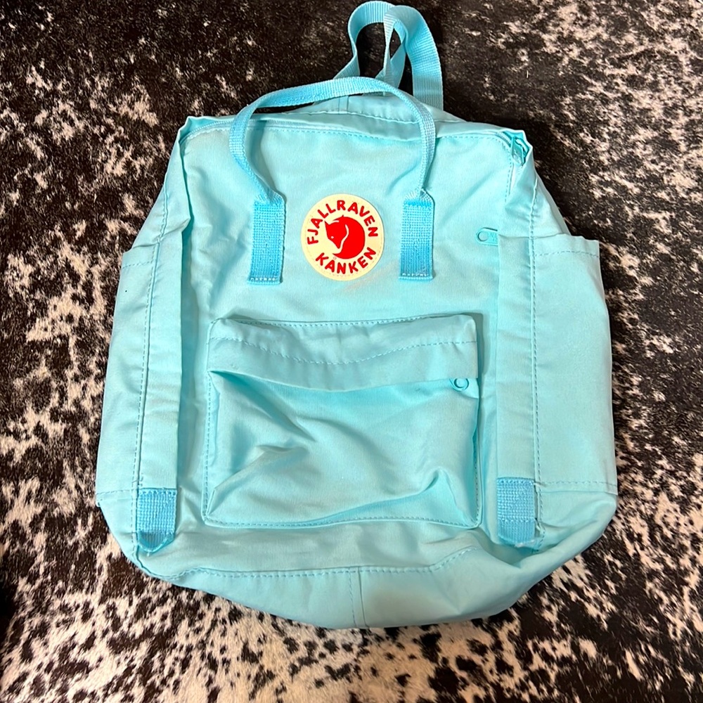 Light blue used KANKEN backpack. No visible stains in very good condition.